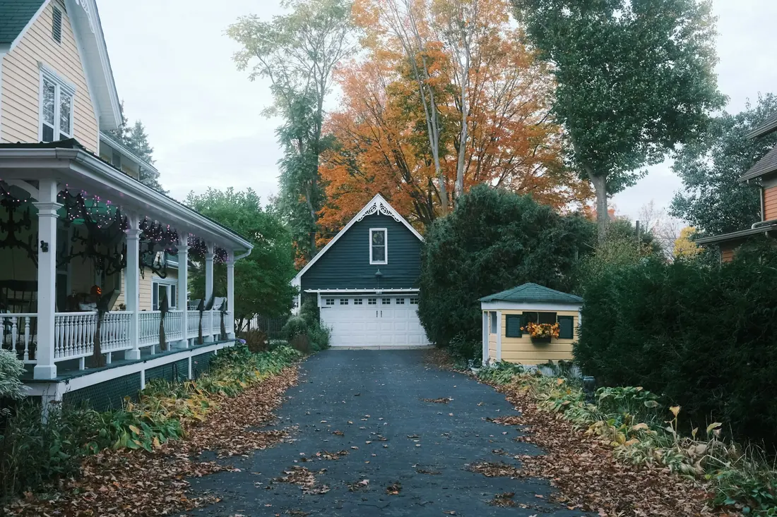 A shared driveway running back between houses to a garage